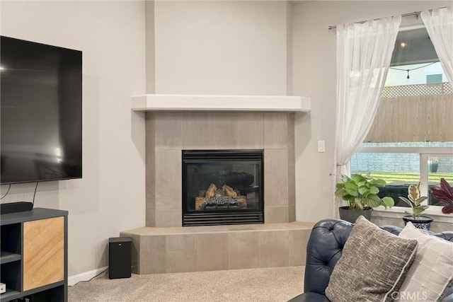 interior space with baseboards, carpet floors, and a glass covered fireplace
