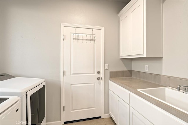 laundry room featuring a sink, cabinet space, and independent washer and dryer