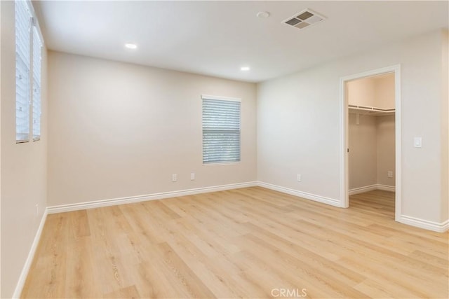 33827 Flora Springs St, Temecula, CA 92592 - unfurnished bedroom with light wood-type flooring, a walk in closet, recessed lighting, and a closet