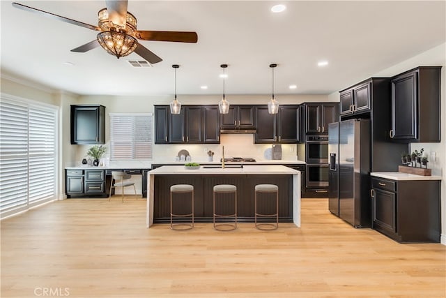 33827 Flora Springs St, Temecula, CA 92592 - kitchen with stainless steel appliances, light countertops, a ceiling fan, light wood-style flooring, and recessed lighting