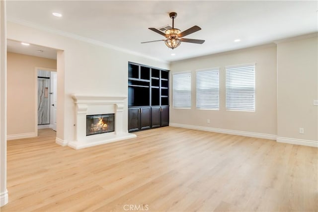 33827 Flora Springs St, Temecula, CA 92592 - unfurnished living room featuring a ceiling fan, wood finished floors, a glass covered fireplace, recessed lighting, and ornamental molding
