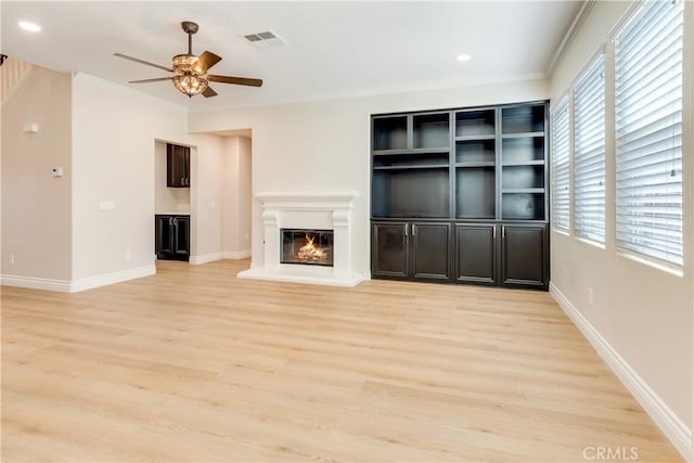 33827 Flora Springs St, Temecula, CA 92592 - unfurnished living room with ceiling fan, light wood finished floors, crown molding, a glass covered fireplace, and recessed lighting