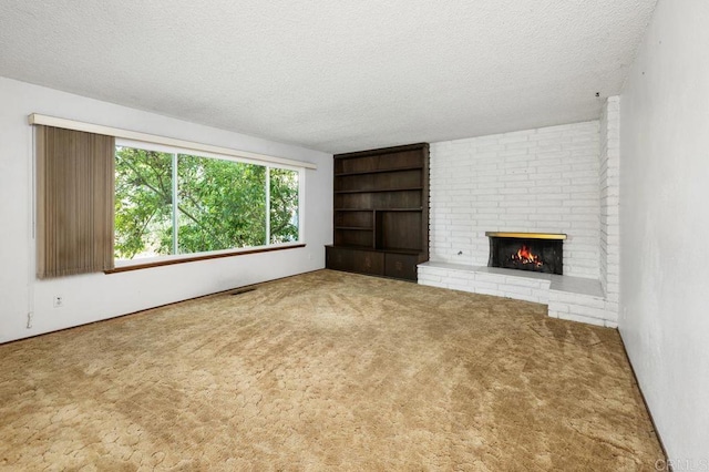 unfurnished living room featuring a textured ceiling, carpet flooring, built in features, and a fireplace