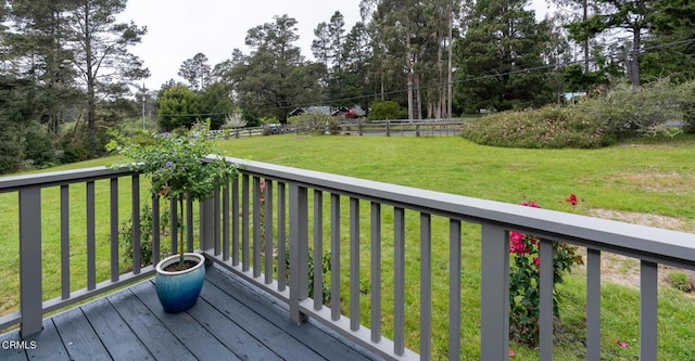wooden terrace with a lawn