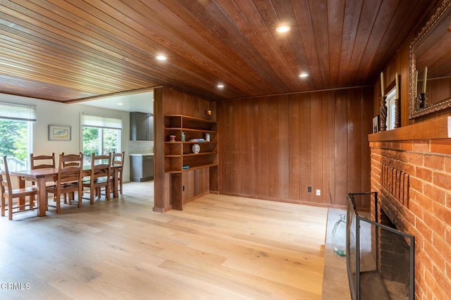 living room featuring wood ceiling, wooden walls, recessed lighting, and light wood finished floors