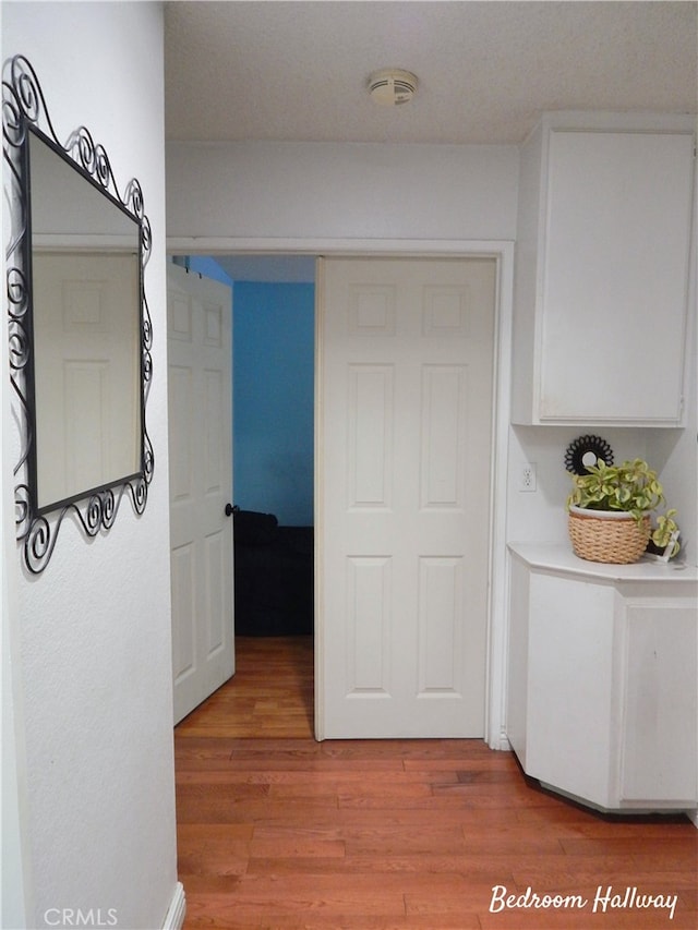 corridor featuring light wood-style floors