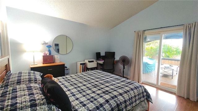 bedroom with wood finished floors, access to exterior, a textured ceiling, and vaulted ceiling
