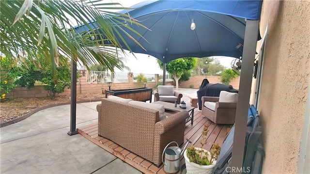 view of patio / terrace featuring a fenced backyard, a gazebo, a wooden deck, and outdoor lounge area