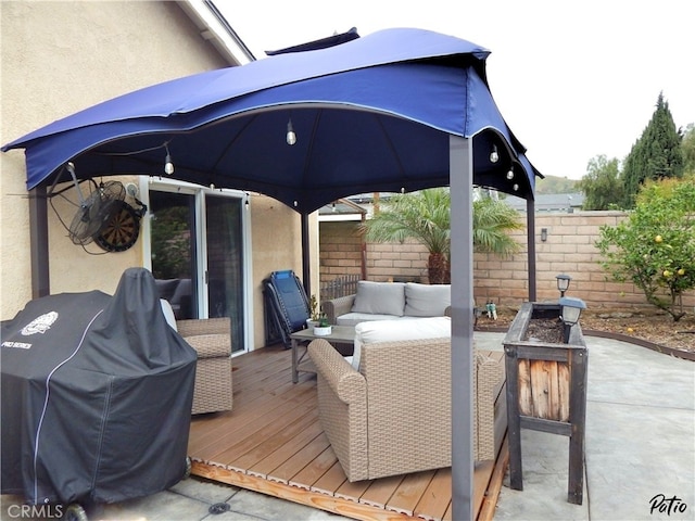 view of patio / terrace featuring area for grilling, outdoor lounge area, fence, a deck, and a gazebo