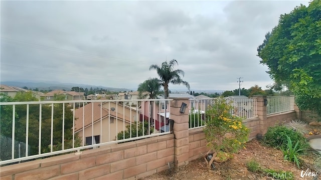 view of gate with fence and a residential view