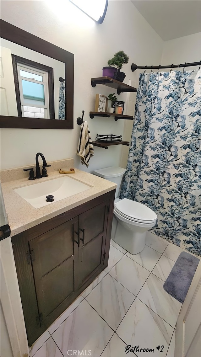 bathroom with toilet, marble finish floor, vanity, and a shower with shower curtain