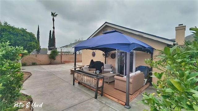 view of patio with fence and an outdoor hangout area