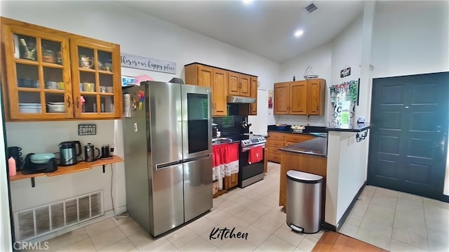 kitchen featuring a peninsula, stainless steel appliances, brown cabinets, visible vents, and dark countertops