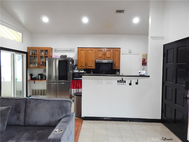 kitchen with glass insert cabinets, brown cabinets, smart refrigerator, visible vents, and under cabinet range hood