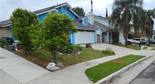 view of front facade featuring driveway, a shingled roof, a front yard, and an attached garage