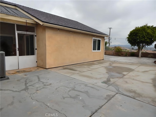 11622 Remington St, Sylmar, CA 91342 - view of side of home with a patio area, fence, stucco siding, and a shingled roof