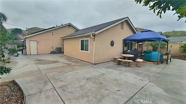 11622 Remington St, Sylmar, CA 91342 - back of property with stucco siding, a patio area, central AC unit, and fence
