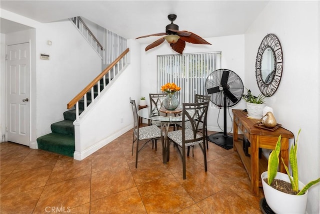 15910 Peach Tree Ln, Fontana, CA 92337 - tiled dining room with ceiling fan, stairway, and baseboards