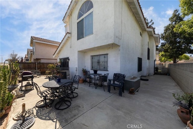 15910 Peach Tree Ln, Fontana, CA 92337 - back of house with stucco siding, fence, a patio, and outdoor dining area