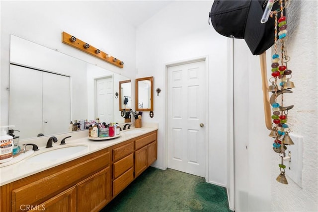 full bathroom with double vanity and a sink