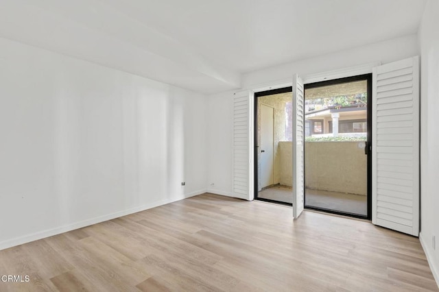 interior space with wood finished floors and baseboards