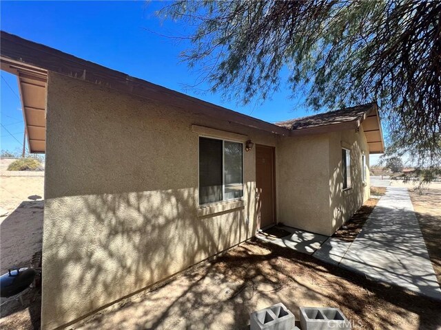 6476 Desert Knoll Ave Unit 29, Palms, CA 92277 - view of home's exterior featuring a patio and stucco siding
