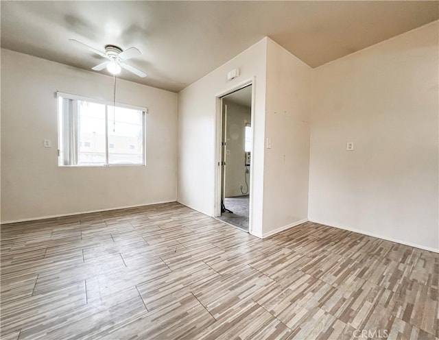 empty room featuring ceiling fan and wood finished floors