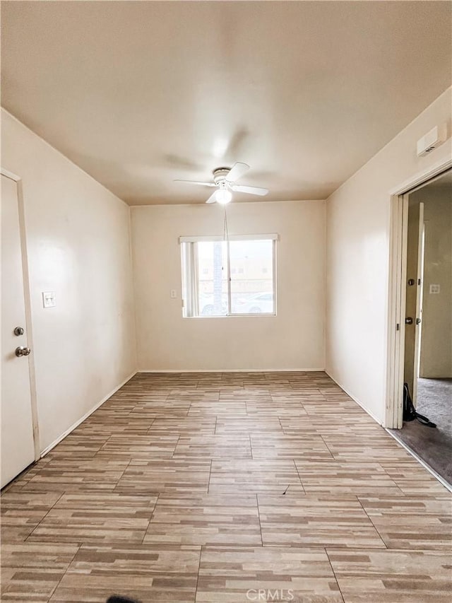 unfurnished room with light wood-style floors and ceiling fan