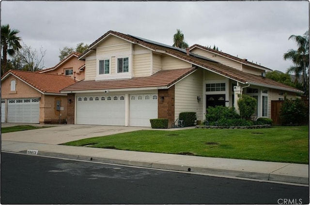 10075 Desert Mallow, Moreno Valley, CA 92557 - view of front of home featuring concrete driveway, a front yard, a tiled roof, and an attached garage