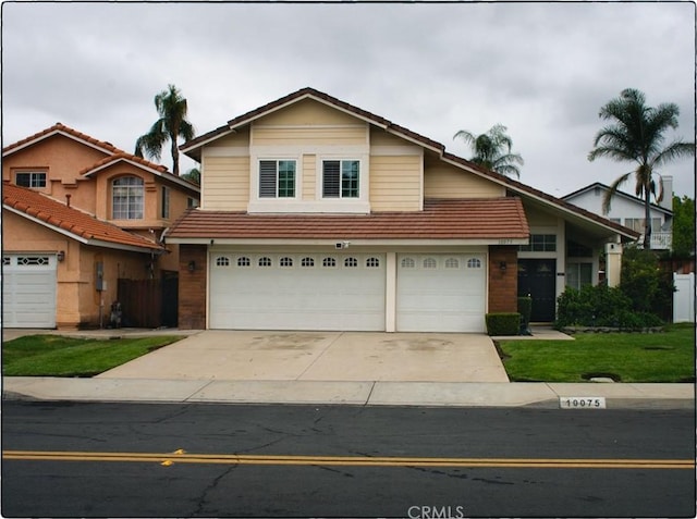 10075 Desert Mallow, Moreno Valley, CA 92557 - view of front of home featuring a tile roof, concrete driveway, an attached garage, and a front yard