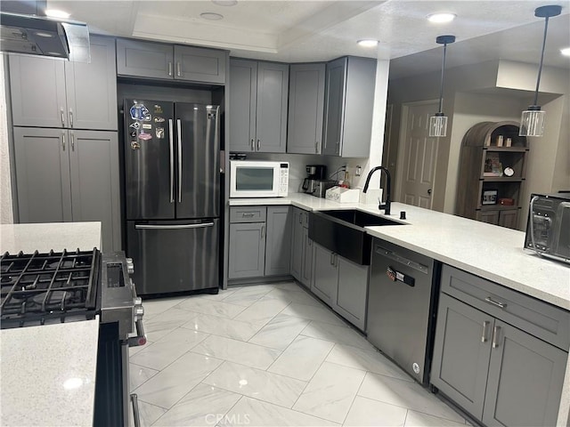 10075 Desert Mallow, Moreno Valley, CA 92557 - kitchen with appliances with stainless steel finishes, gray cabinetry, a sink, wall chimney exhaust hood, and light countertops