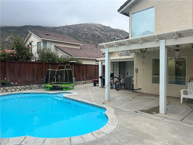 10075 Desert Mallow, Moreno Valley, CA 92557 - view of pool featuring a mountain view, a patio, a pergola, fence, and a fenced in pool