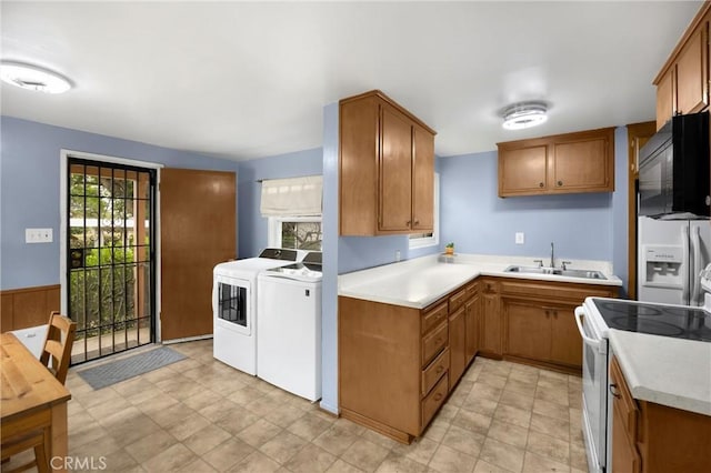 kitchen featuring separate washer and dryer, a sink, black microwave, white electric range, and refrigerator with ice dispenser