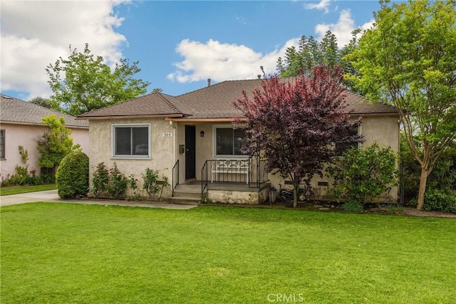 ranch-style home with covered porch, stucco siding, and a front yard