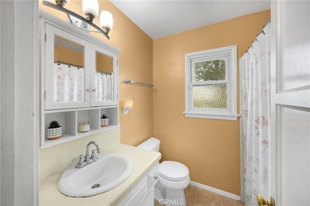 full bathroom with tasteful backsplash, tile patterned floors, toilet, vanity, and baseboards
