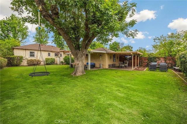 back of property with a patio, a fenced backyard, stucco siding, and a yard