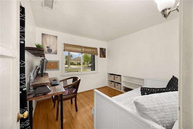 bedroom featuring visible vents and wood finished floors