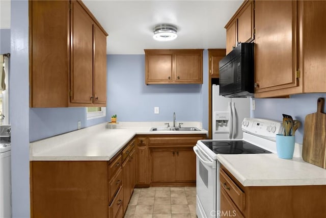 kitchen with white appliances, light countertops, brown cabinetry, and a sink