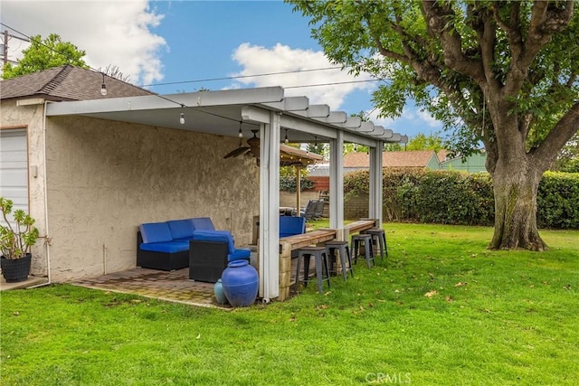 view of yard featuring a patio, fence, and outdoor dry bar