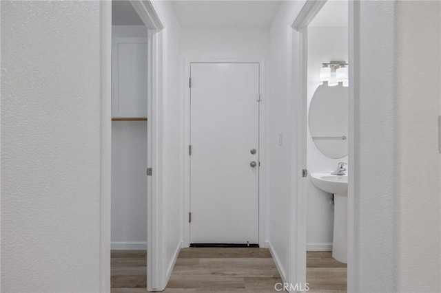 interior space with baseboards and light wood-type flooring