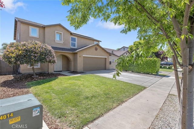 traditional-style house with driveway, fence, stucco siding, a front lawn, and a garage