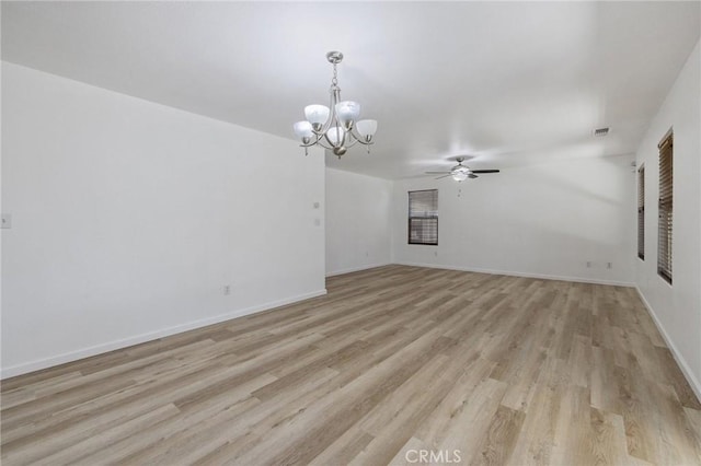 unfurnished living room with visible vents, light wood-type flooring, baseboards, and ceiling fan with notable chandelier
