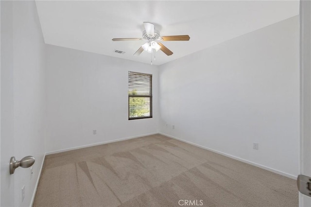 unfurnished room with visible vents, a ceiling fan, carpet flooring, and baseboards