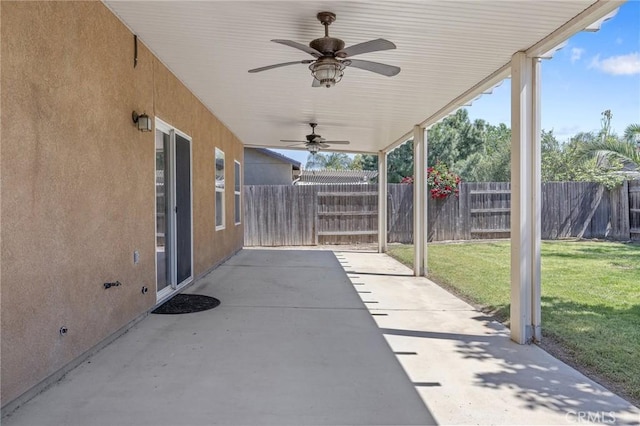 view of patio featuring ceiling fan and fence