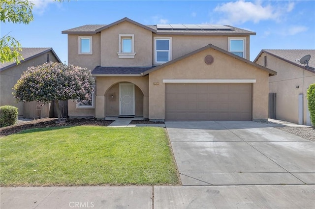 traditional-style home with a front yard, driveway, solar panels, and stucco siding