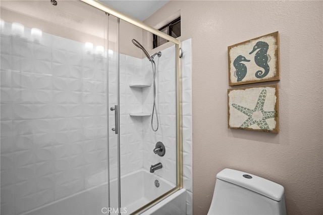 full bathroom with enclosed tub / shower combo and toilet