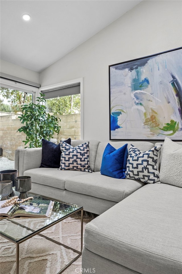 living room featuring lofted ceiling, plenty of natural light, and recessed lighting