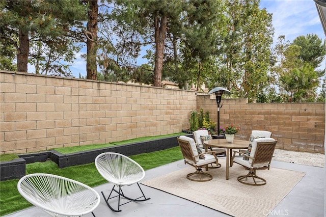 view of patio / terrace with outdoor dining space and a fenced backyard