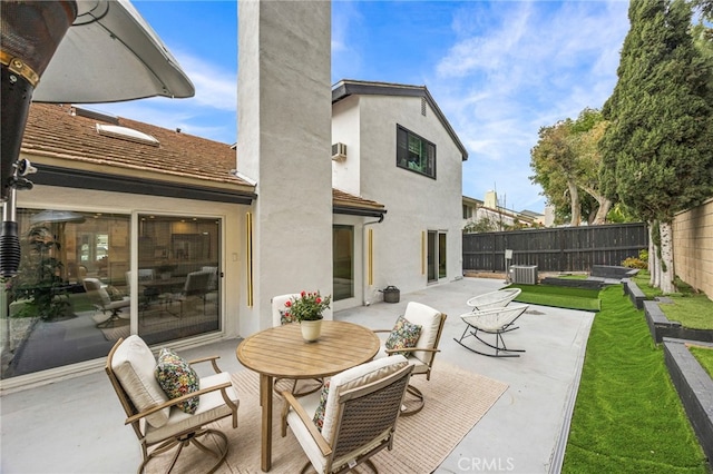 back of house featuring cooling unit, a patio, a chimney, stucco siding, and fence