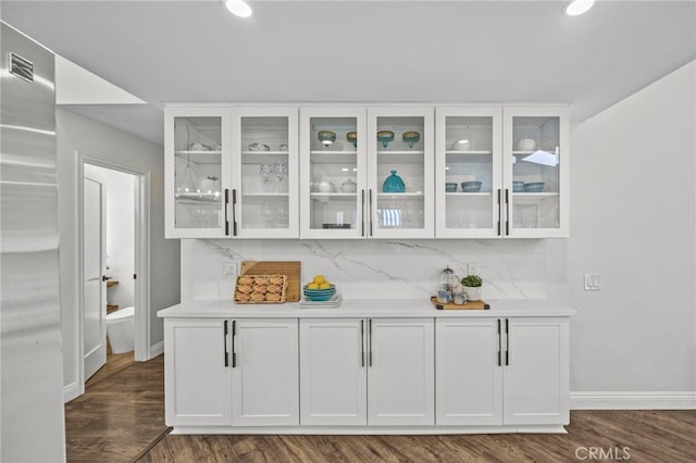 bar with dark wood finished floors, recessed lighting, backsplash, baseboards, and visible vents